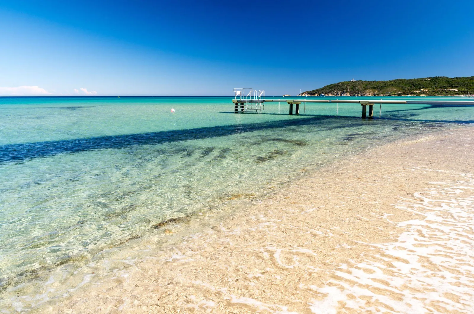 Clear water and a wooden jetty at Pampelonne beach, Ramatuelle